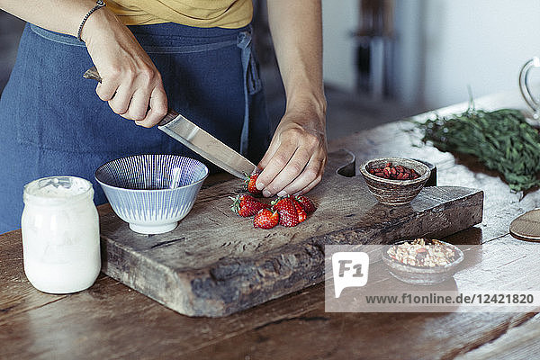 Woman preparing cutting strawberries on cutting board