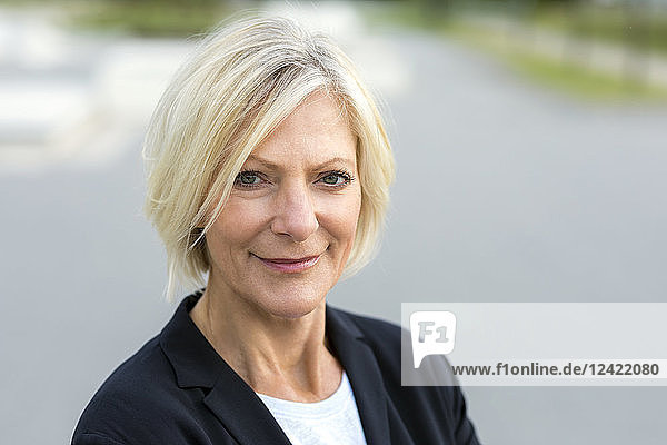 Portrait of confident senior businesswoman outdoors