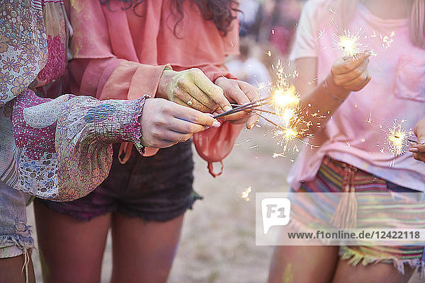 Women having fun with sparklers at music festival