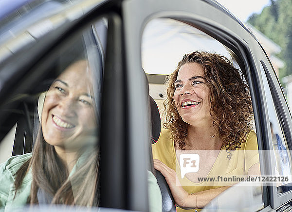 Two happy women in electric bubble car