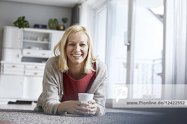 Happy woman relaxing at home  drinking coffee