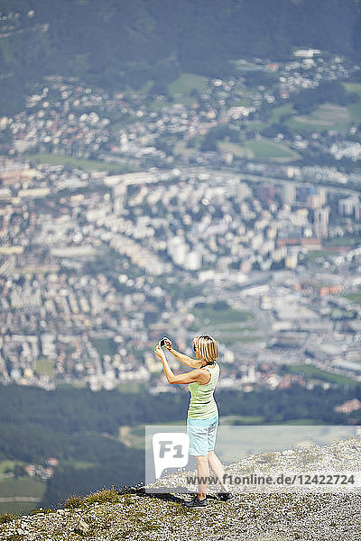 Austria  Tyrol  Woman taking picture of Innsbruck