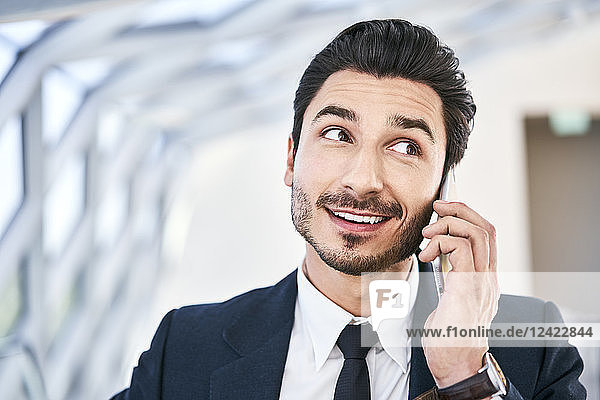Portait of smiling businessman on cell phone