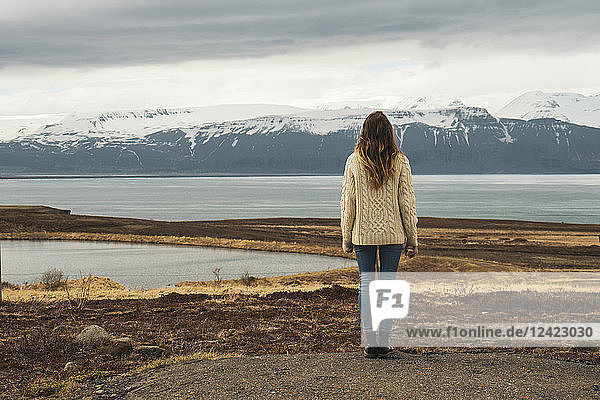 Iceland  woman standing at lakeside