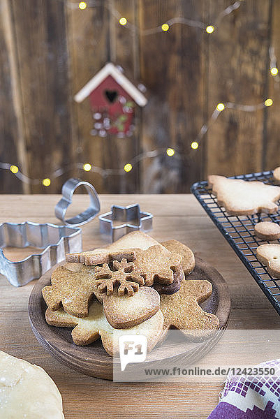 Various home-baked gingerbread cookies on wooden plate
