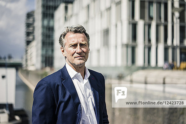 Portrait of mature businessman outdoors in the city