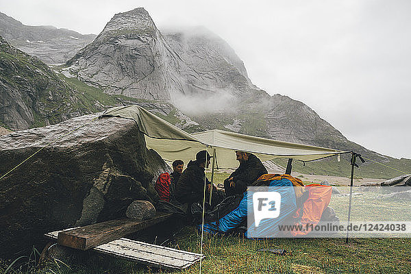 Norway  Lofoten  Moskenesoy  Young men camping at Bunes Beach
