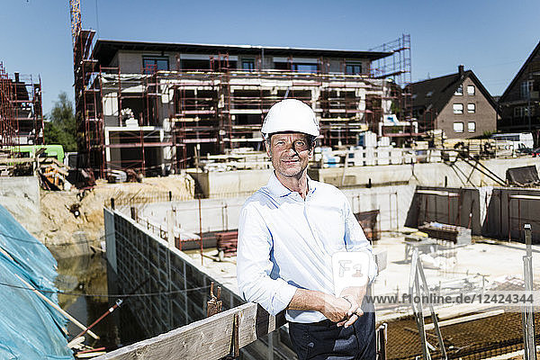 Portrait of confident man wearing hard hat on construction site
