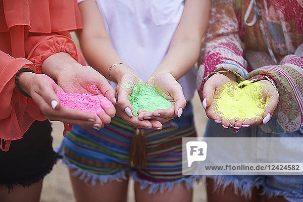 Holi colors in hands of women
