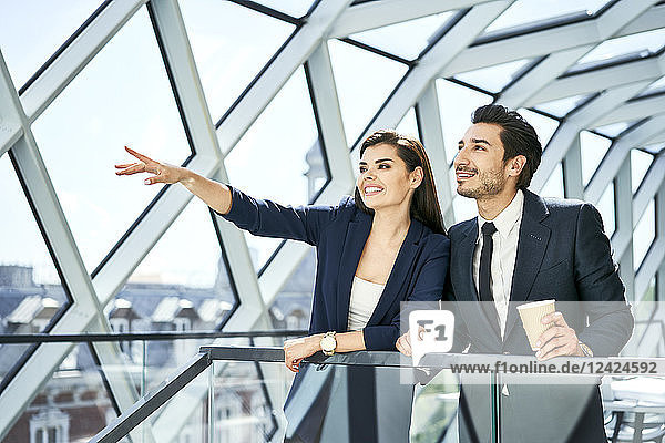 Businesswoman and businessman talking in modern office