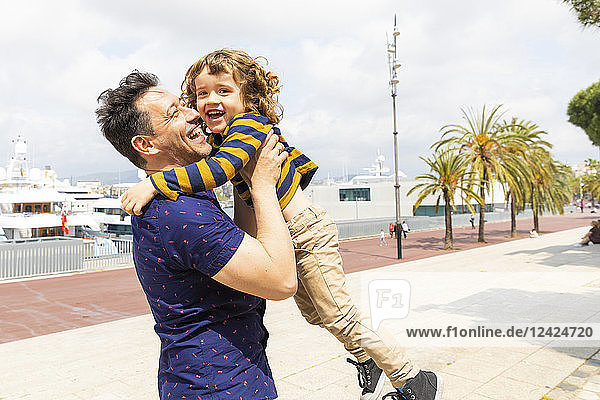 Spain  Barcelona  father and son playing together and having fun