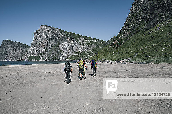 Norway  Lofoten  Moskenesoy  Young men hiking to Kvavika Beach