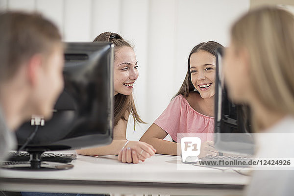 Students talking in computer class