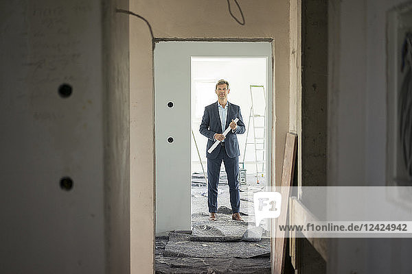 Architect standing in building under construction