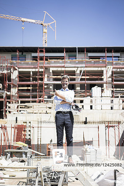 Portrait of happy man standing on construction site