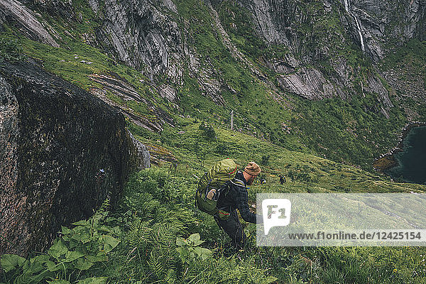 Norway  Lofoten  Moskenesoy  Man hiking downhill