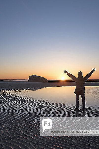 USA  Massachusetts  Cape Cod  Orleans  Man watching sunset at beach