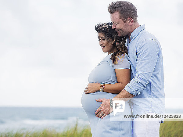 Ein schwangeres Paar in der Umarmung