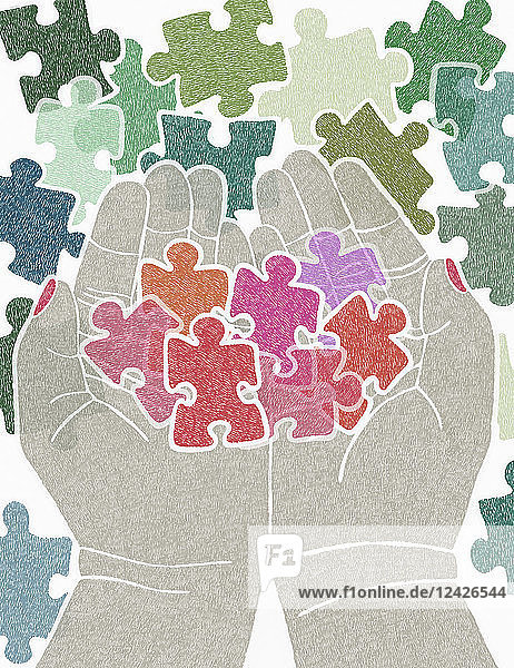 Cupped hands holding pink jigsaw puzzle piece figures
