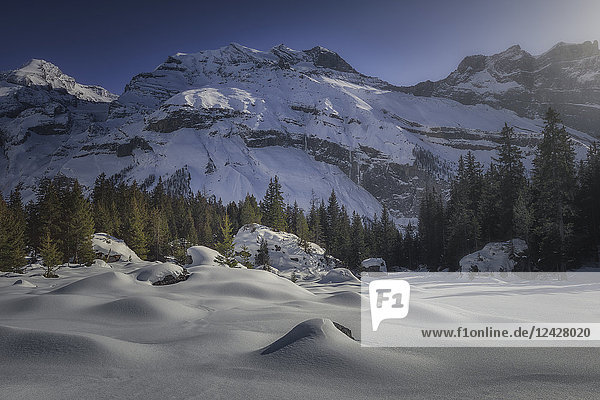 Majestic natural scenery with snow covered mountains in winter Switzerland