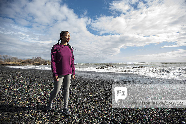 Full length portrait of single female runner on gravel beach  Kittery  Maine  USA