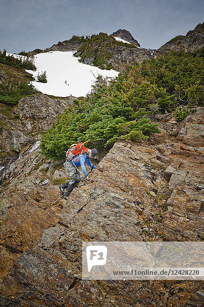 Side view of single male mountain climber climbing Foley Peak  North Cascade Mountain Range  Chilliwack  British Columbia  Canada