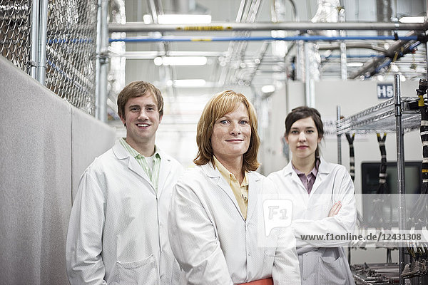 A portrait of a team of technicians in a technical research and development site.