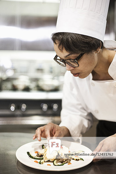 A black female chef working in a commercial kitchen
