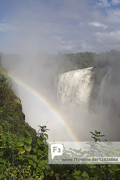 Ein Regenbogen in der Gischt des Victoria-Wasserfalls (Mosi-oa-Tunya)  UNESCO-Weltkulturerbe  an der Grenze zwischen Simbabwe und Sambia  Afrika