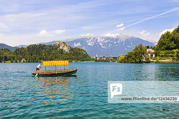 A boat in Lake Bled with Bled Castle in the background  Slovenia  Europe