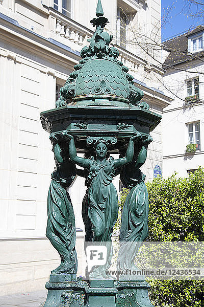 A green Wallace Fountain in the Place St.-Michel Paris France Europe