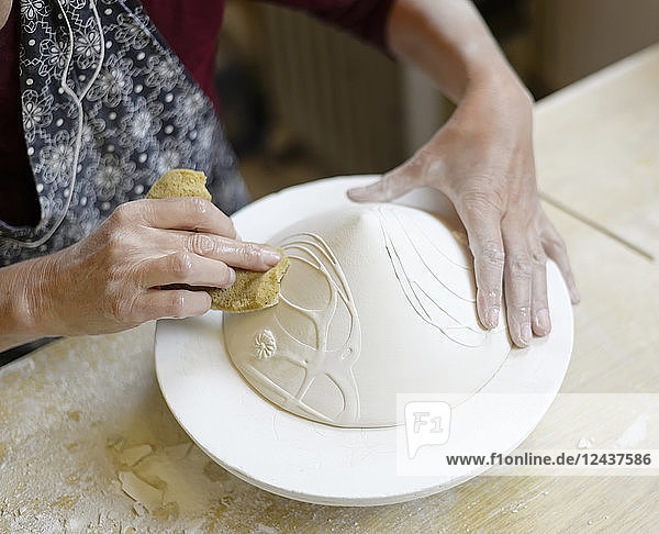 Close-up of woman working in porcelain workshop
