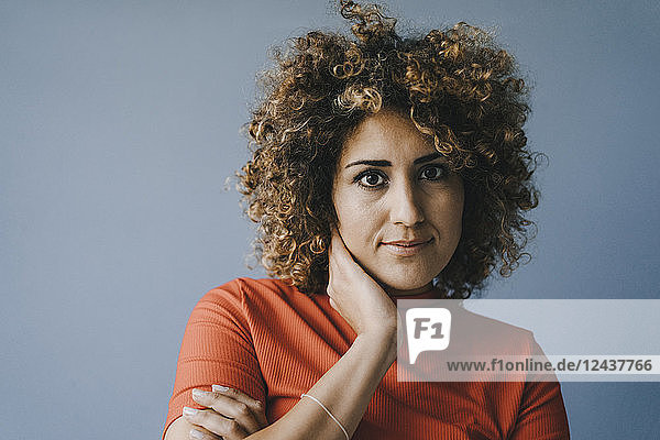 Portrait of a pensive woman with hand on chin