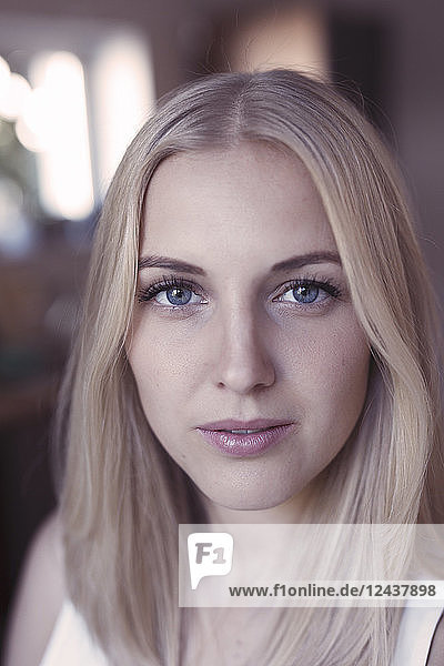 Portrait of young blond woman with blue eyes
