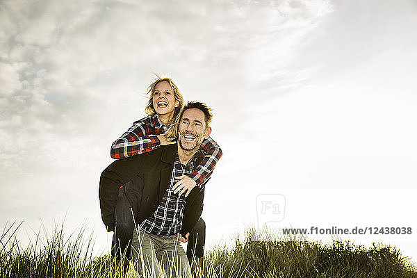 Happy playful couple in dunes
