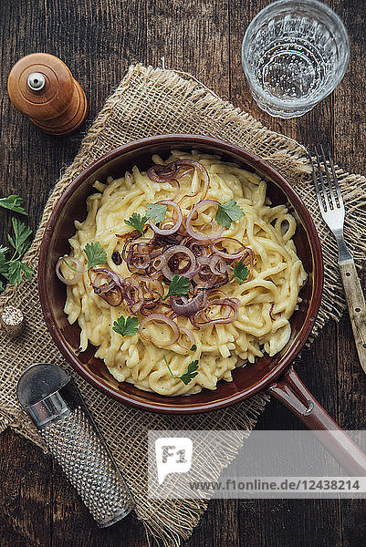 Traditional swabian cheese spaetzle  egg noodles with cheese  cream  roasted onions