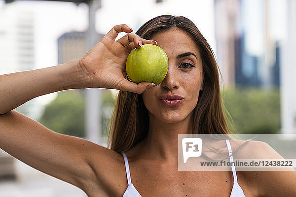 Portrait of attractive young woman holding an apple