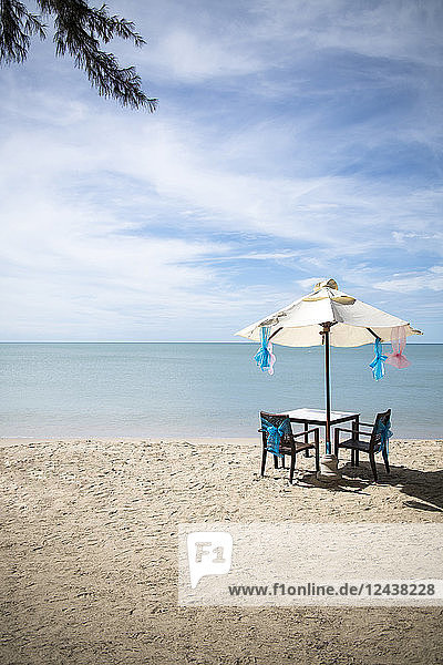 Thailand  Khao Lak  table  chairs and beach umbrella at seaside