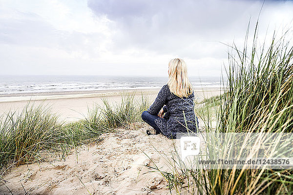 Woman sitting in dunes