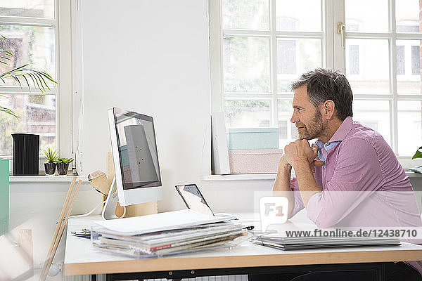 Smiling man working at desk in office