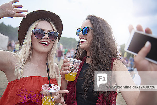 Portrait of women with plastic cups at the music festival