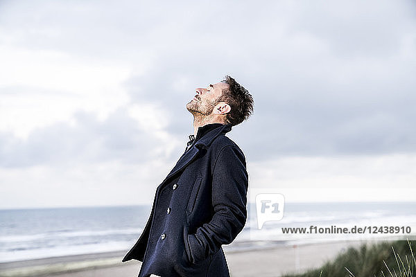Relaxed man with closed eyes on the beach