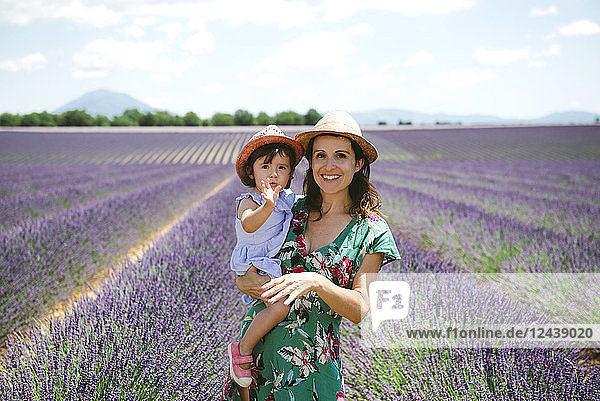 France Provence Valensole plateau portrait of smiling mother and daughter in lavender fields in the summer