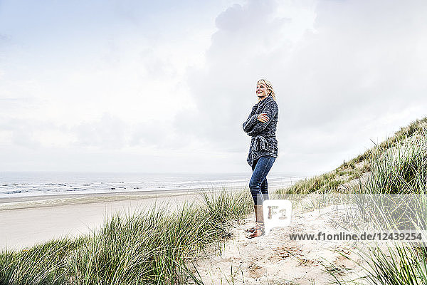 Smiling woman standing in dunes
