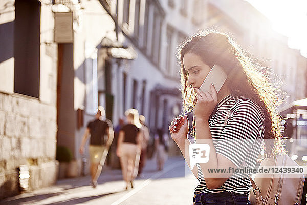 Young woman on cell phone in the city