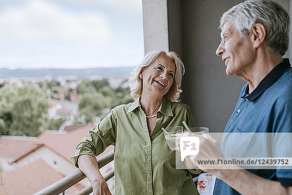 Senior couple talking on balcony