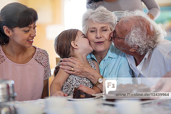 Grandparents celebrating a birthday with their granddaughter