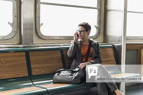 Businesswoman on a ferry on cell phone