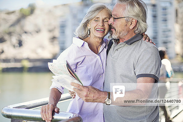 Senior couple taking a city break  holding map