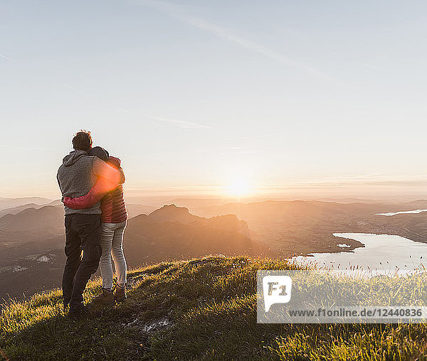 Austria  Salzkammergut  Couple standing on mountain summit  enjoying the view